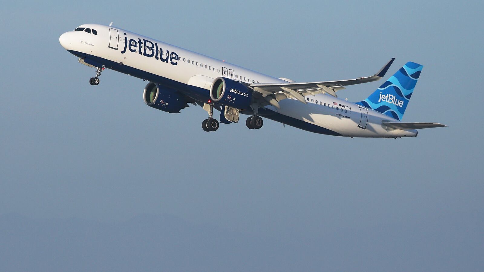 A JetBlue passenger was arrested after allegedly opening an emergency exit and deploying the slide of a taxiing aircraft at Boston Logan International Airport.