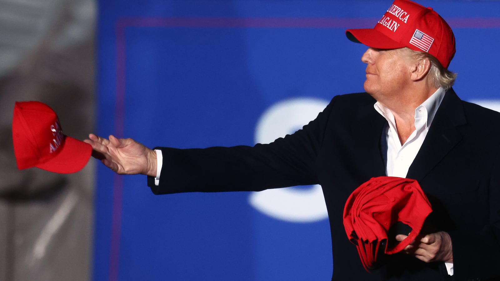 Donald Trump tosses a MAGA hat to the crowd before speaking at a rally at the Canyon Moon Ranch festival grounds on January 15, 2022 in Florence, Arizona.