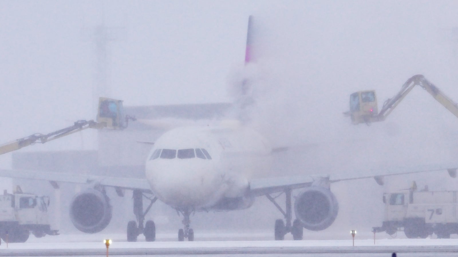 A Delta Air Lines jet is de-iced at Minneapolis-St. Paul International Airport.