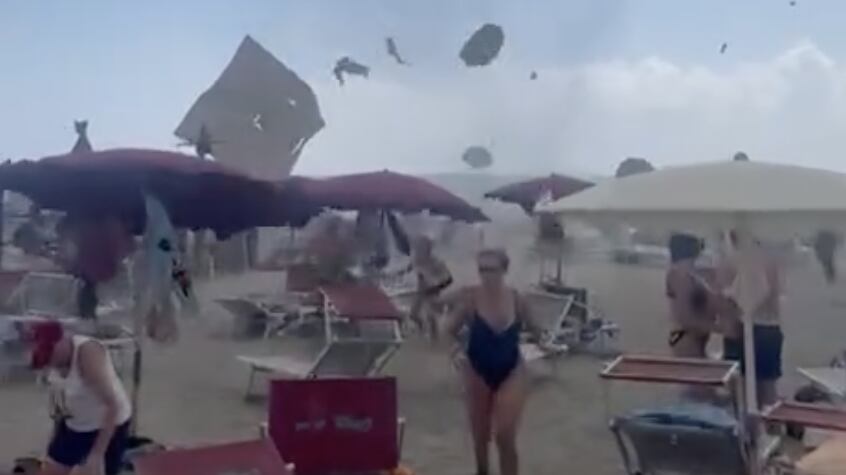 Tourists scramble as a tornado ravages a beach in Northern Italy, sending parasols flying into the air.