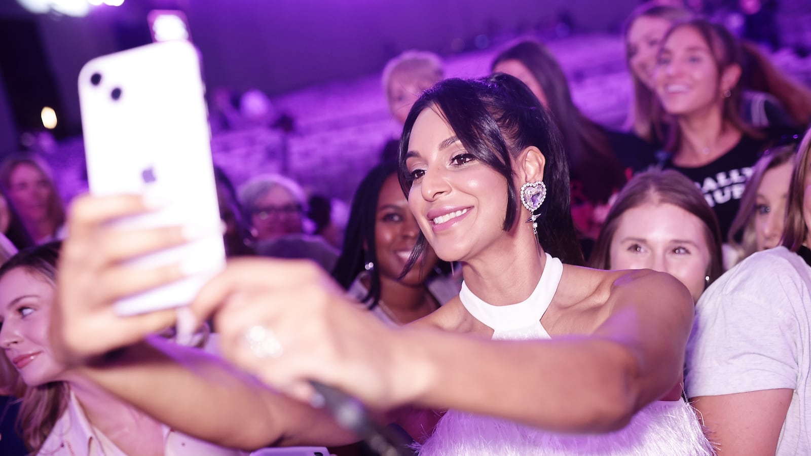 Photo of Jessel Taank taking a selfie with fans at BravoCon.