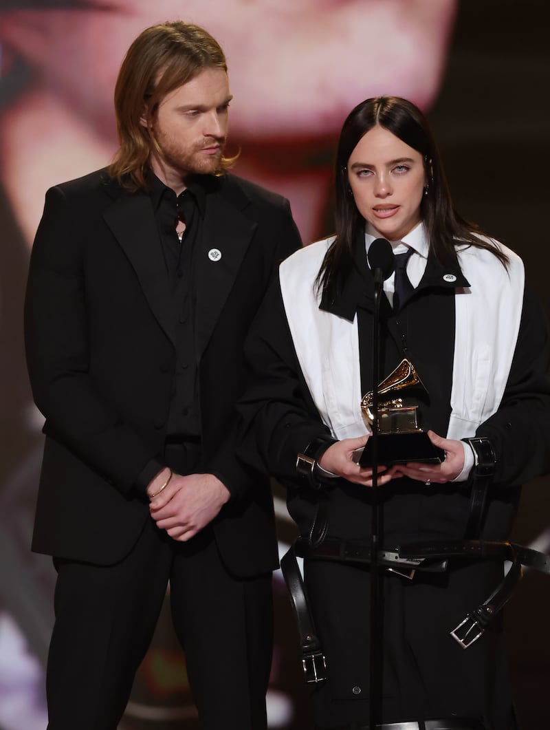 LOS ANGELES, CALIFORNIA - FEBRUARY 01: (L-R) Finneas O'Connell and Billie Eilish accept the Song Of The Year award for “WILDFLOWER” onstage during the 68th GRAMMY Awards at Crypto.com Arena on February 01, 2026 in Los Angeles, California.  (Photo by Kevin Winter/Getty Images for The Recording Academy)
