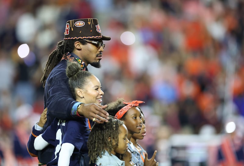 Former Auburn Tigers quarterback Cam Newton poses with his family