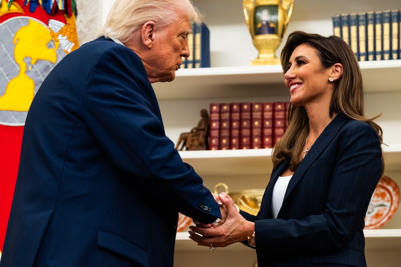 US President Donald Trump shaking hands with Alina Habba in the Oval Office on Friday, March 28, 2025.