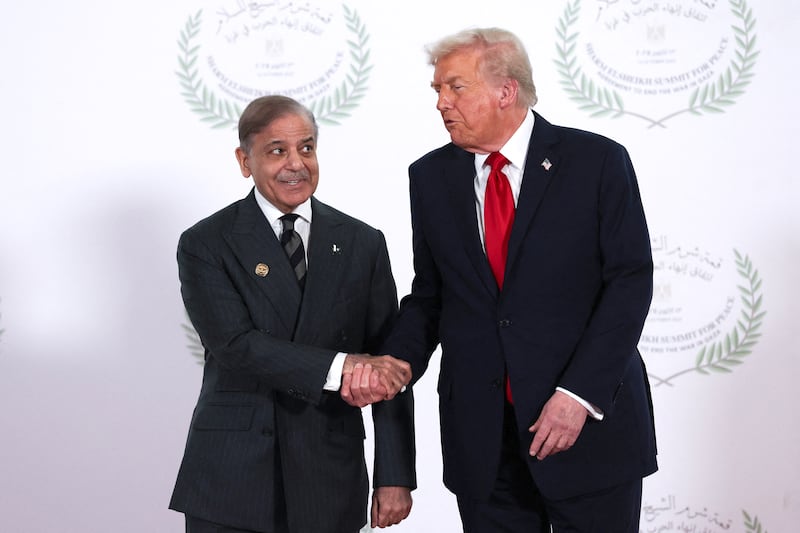 U.S. President Donald Trump and Pakistani Prime Minister Shehbaz Sharif shake hands as they pose for a photo during a world leaders' summit on ending the Gaza war on October 13, 2025 in Sharm El-Sheikh, Egypt.