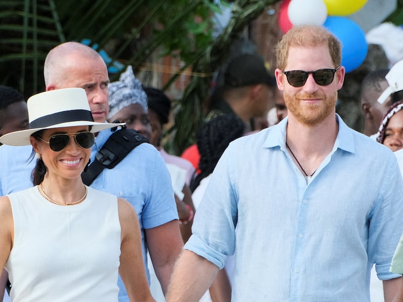 Britain's Prince Harry and his wife Meghan, Duchess of Sussex, walk together in San Basilio de Palenque, Colombia August 17, 2024. REUTERS/Rafael Bossio