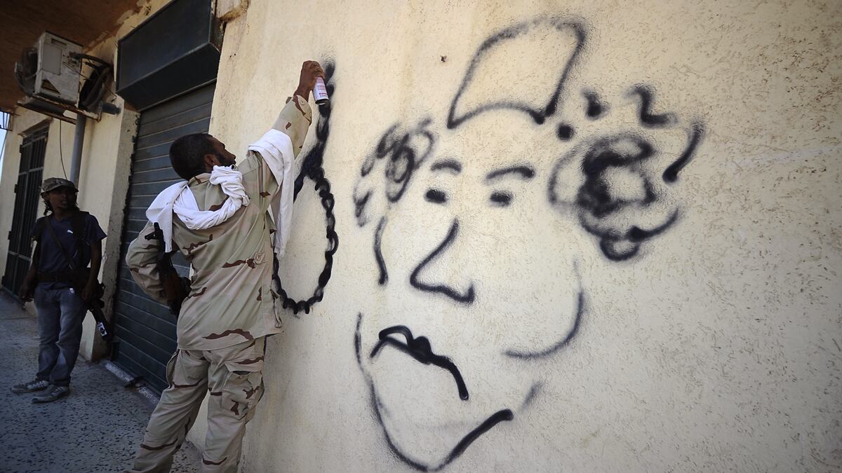 articles/2011/08/21/libyan-rebels-surround-tripoli-and-muammar-gaddafi/libya-rebels-graffiti-gadayem_ubiaqj