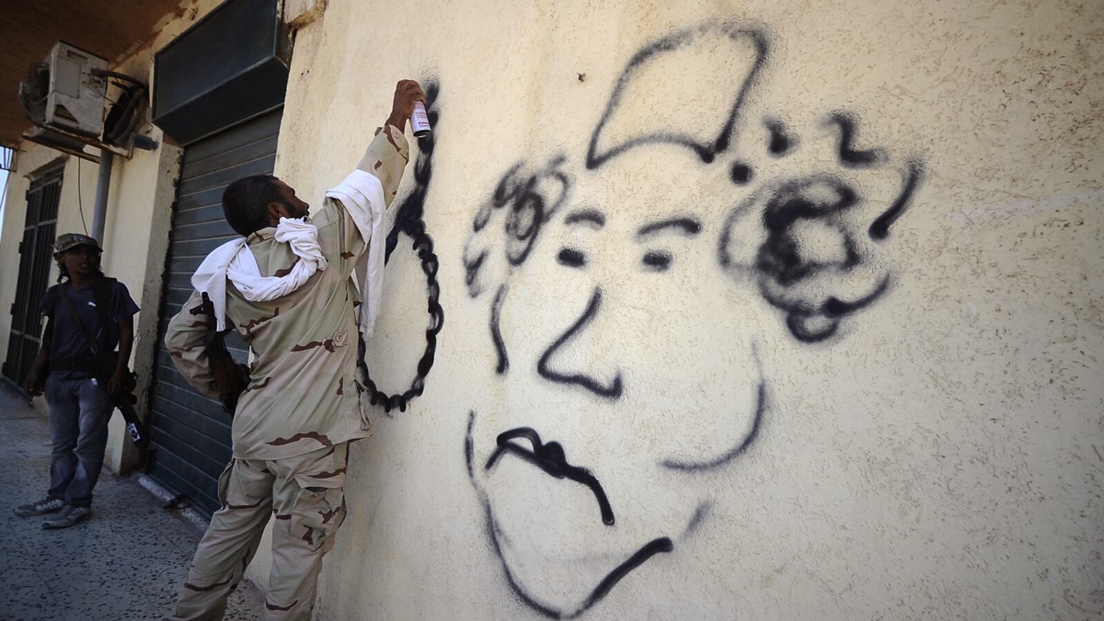 articles/2011/08/21/libyan-rebels-surround-tripoli-and-muammar-gaddafi/libya-rebels-graffiti-gadayem_ubiaqj