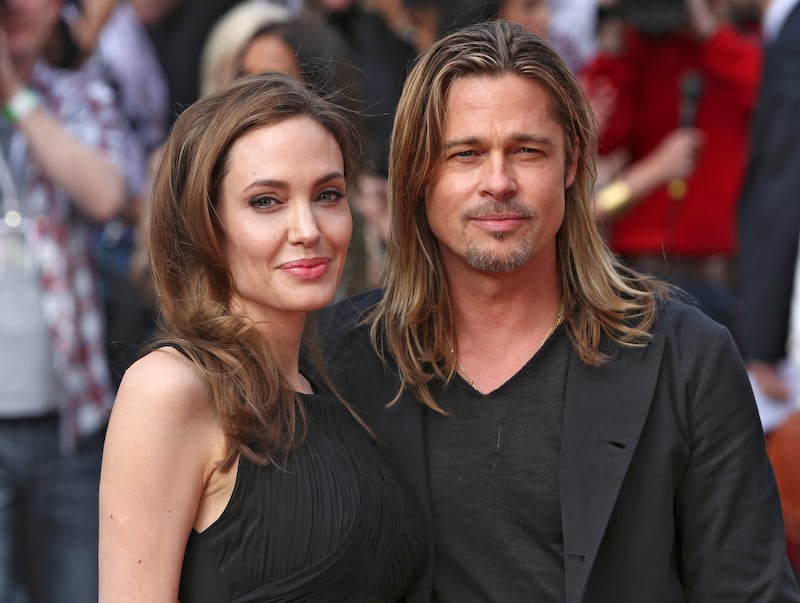 Angelina Jolie poses with her fiance  Brad Pitt as they arrive for the world premiere of his film World War Z in London June 2, 2013.  REUTERS/Neil Hall (BRITAIN  - Tags: ENTERTAINMENT TPX IMAGES OF THE DAY)