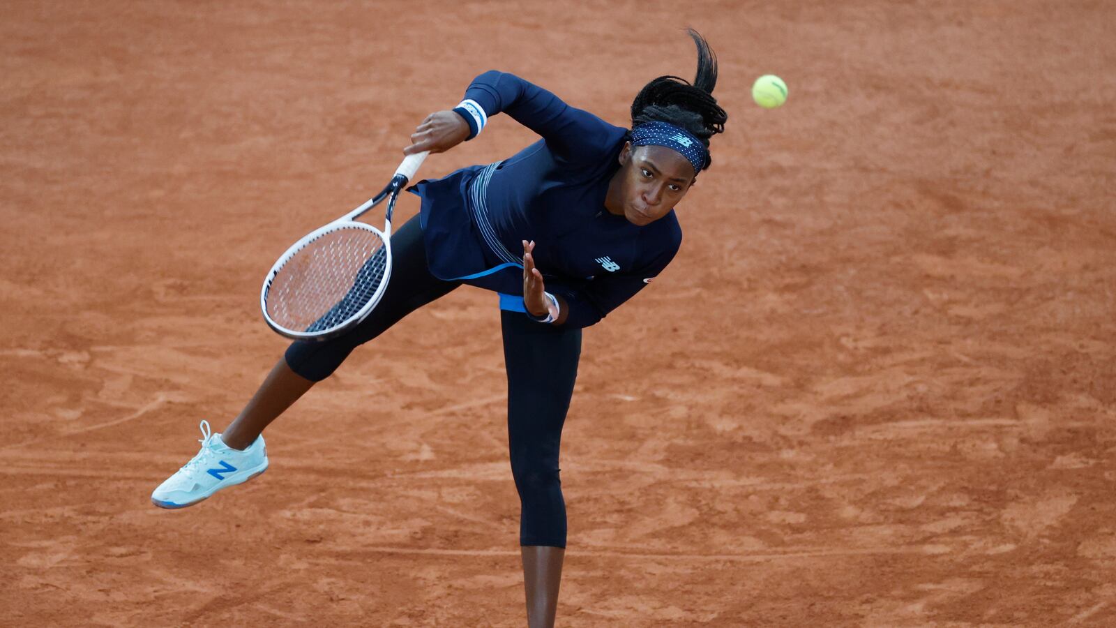 Coco Gauff serving.