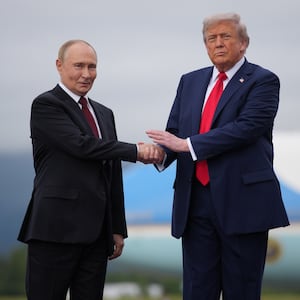 ANCHORAGE, ALASKA - AUGUST 15: U.S. President Donald Trump (R) greets Russian President Vladimir Putin as he arrives at Joint Base Elmendorf-Richardson on August 15, 2025 in Anchorage, Alaska. The two leaders are meeting for peace talks aimed at ending the war in Ukraine.  (Photo by Andrew Harnik/Getty Images)