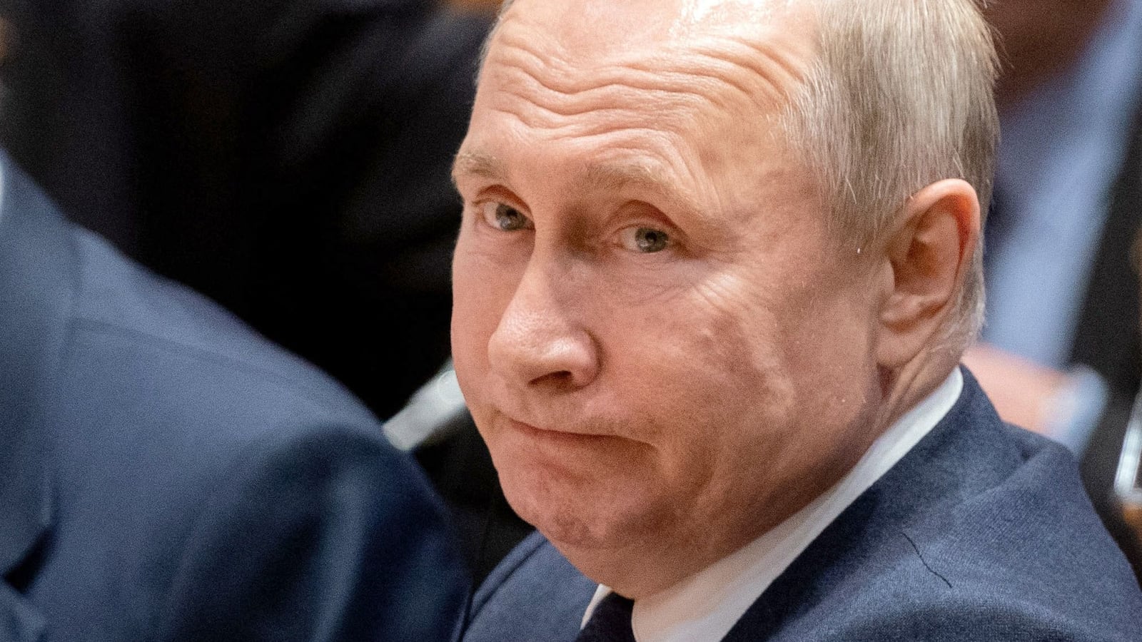 Acting Russian Foreign Minister Sergei Lavrov sits next to Russian President Vladimir Putin at the start of a Peace summit on Libya at the Chancellery in Berlin.