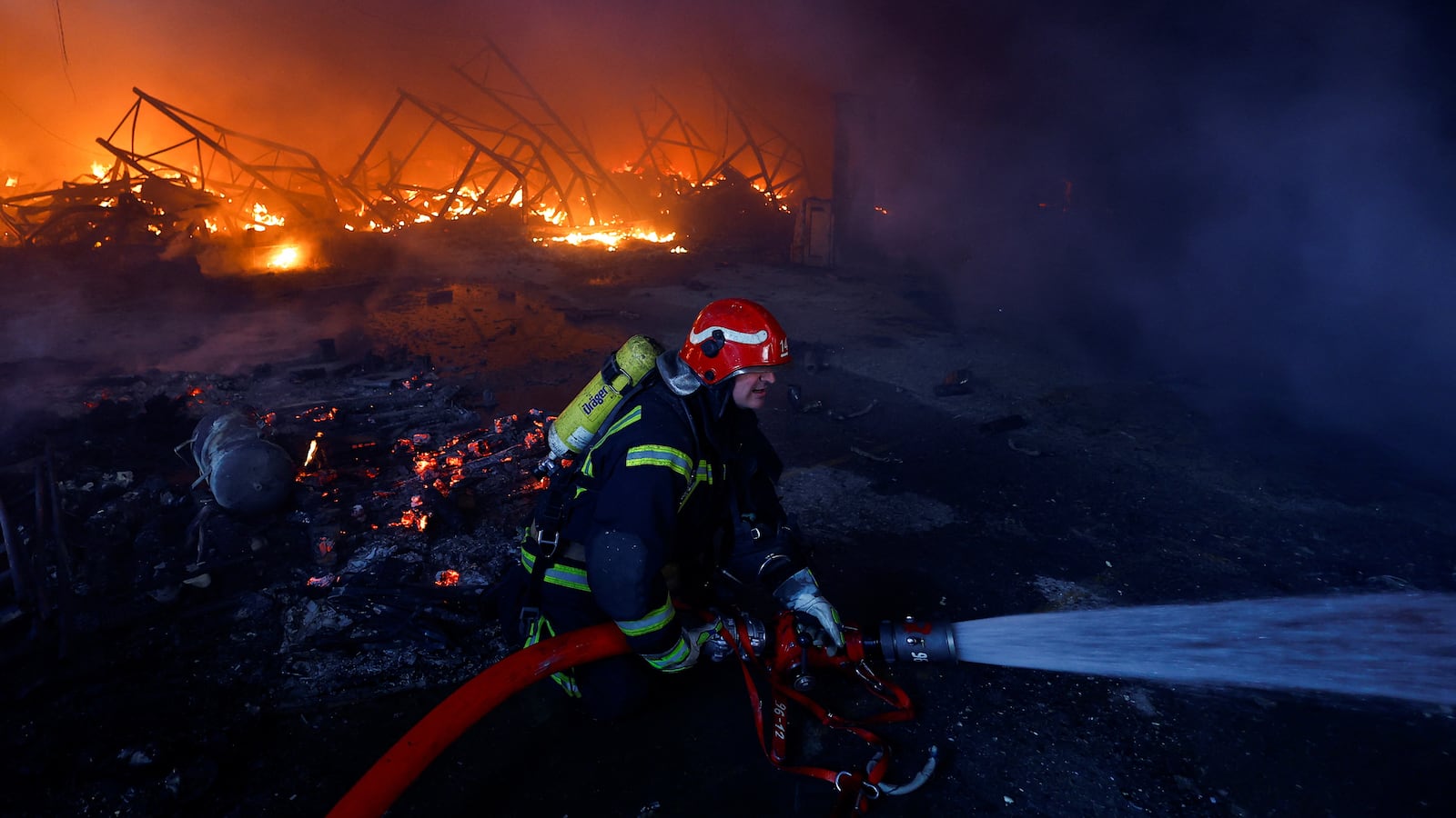 A firefighter works at a site of a warehouse heavily damaged during a Russian missile strike, amid Russia’s attack on Ukraine, in Kyiv, Ukraine December 29, 2023.