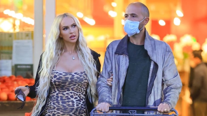 Christine Quinn walks alongside her husband, Christian Dumontet, at a grocery store.