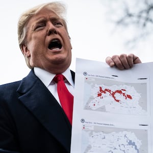 WASHINGTON, DC - MARCH 20 : President Donald J. Trump stops to speak to reporters and members of the media and to show a map of ISIS controlled territory as he walks to Marine One to depart from the South Lawn at the White House on Wednesday, March 20, 2019 in Washington, DC. (Photo by Jabin Botsford/The Washington Post via Getty Images)