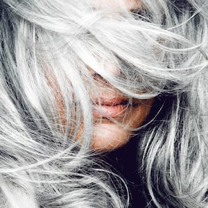 Woman tossing her silver hair.
