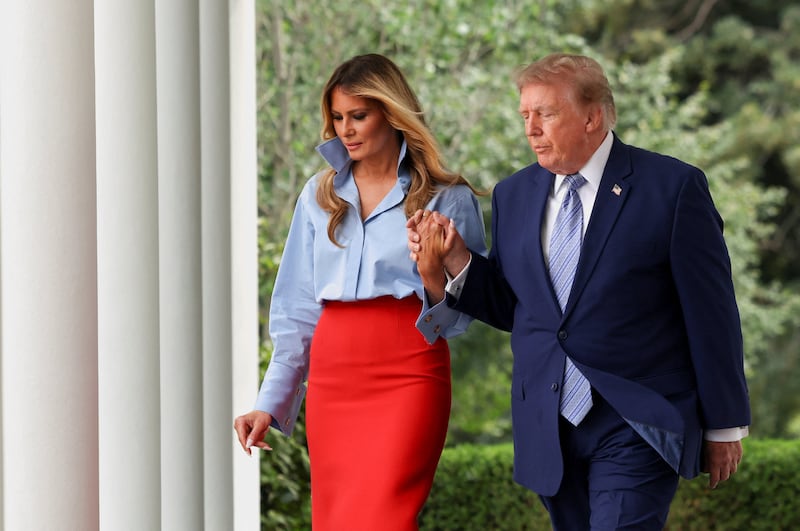 U.S. President Donald Trump and first lady Melania Trump walk together to participate in a Fostering the Future announcement in the Rose Garden of the White House in Washington, D.C., August 20, 2026.   REUTERS/Tierney Cross