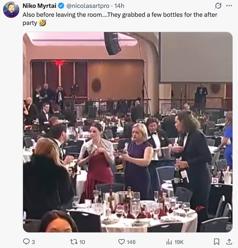 WHCD attendees gather wine bottles before leaving the room following the shooting.