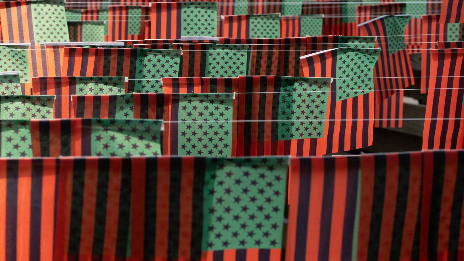 UNIA flags bask in the sun at a block party to mark Juneteenth.