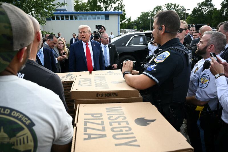Donald Trump gave federal troops pizza and burgers during an impromptu publicity stunt on Thursday.