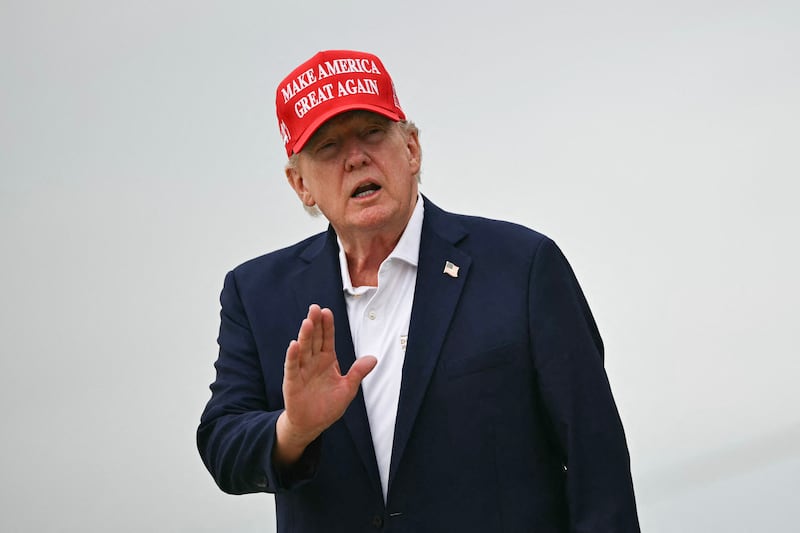 US President Donald Trump gestures as he steps off Air Force One upon arrival at Joint Base Andrews in Maryland on August 16, 2026. President Trump is returning to Washington, DC, after spending the weekend at his golf club in New Jersey. (Photo by Kent NISHIMURA / AFP via Getty Images)