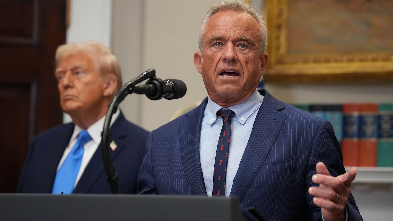 Robert F. Kennedy Jr., joined by President Donald Trump (L) in the Roosevelt Room of the White House on September 22, 2025 in Washington, DC.