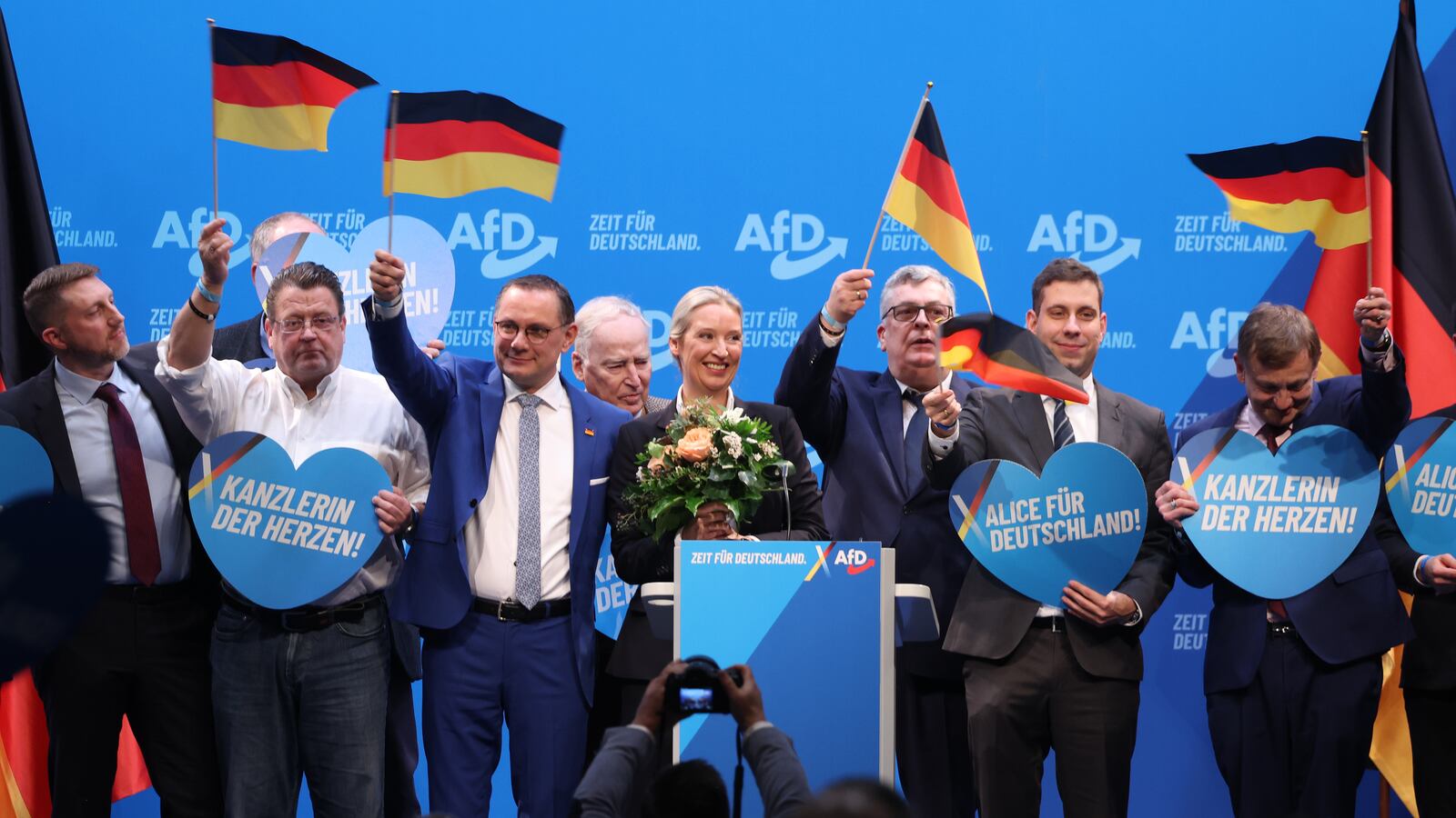 Alice Weidel (C) and Tino Chrupalla (C-L), co-leaders of the far-right AfD political party wave German flags and stand on stage after delegates confirmed Weidel as the party's chancellor candidate on January 11, 2025 in Riesa, Germany.