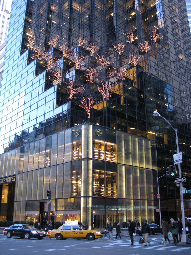 Trump Tower from the street showing a taxi and a black towncar in front