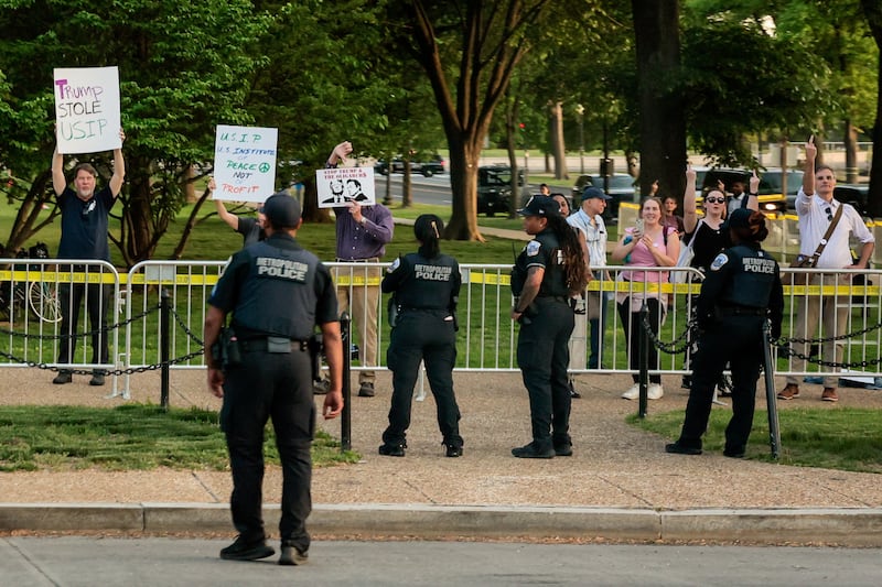 Demonstrators flipped off the president’s motorcade as it passed.