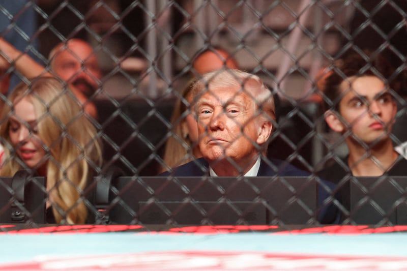 U.S. President Donald Trump watches a match during the UFC 327 event
