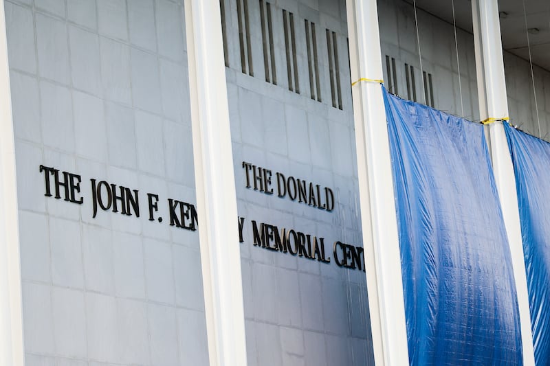 Workers adjust the name of the “John F. Kennedy Memorial Center for the Performing Arts" on December 19, 2025 in Washington, DC to add Donald Trump's name.