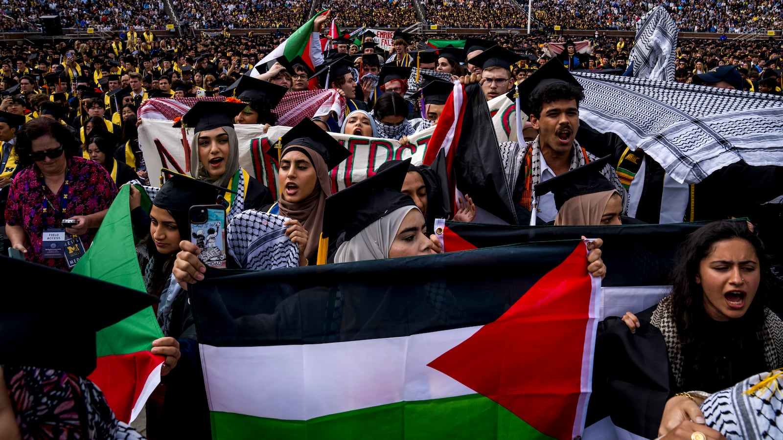 Students demonstrate during a Pro-Palestinian protest during the University of Michigan's spring commencement ceremony on May 4, 2024 at Michigan Stadium in Ann Arbor, Michigan.