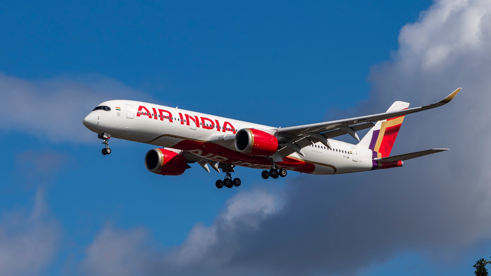 Air India Airbus A350-900 aircraft spotted flying for landing at the runway of London Heathrow Airport LHR in the United Kingdom. The modern and advanced wide body airplane has the registration tail number VT-JRI and is powered by 2x RR Trent XWB jet engines. The A350 passenger plane is arriving from Delhi DEL AI111 a long haul flight. Air India is the flag carrier airline of India with a fleet of 142 aircraft, owned by Air India Limited a Tata Group enterprise with main hub at Indira Gandhi International Airport in Delhi, member of Star Alliance aviation group. September 11, 2024 (Photo by Nicolas Economou/NurPhoto via Getty Images)