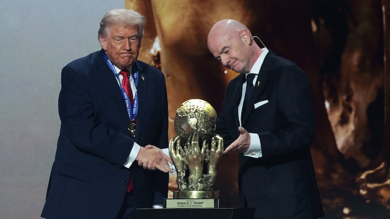President Donald Trump shakes hands with FIFA President Gianni Infantino after being awarded the inaugural FIFA Peace Prize during the FIFA World Cup 2026 Draw.