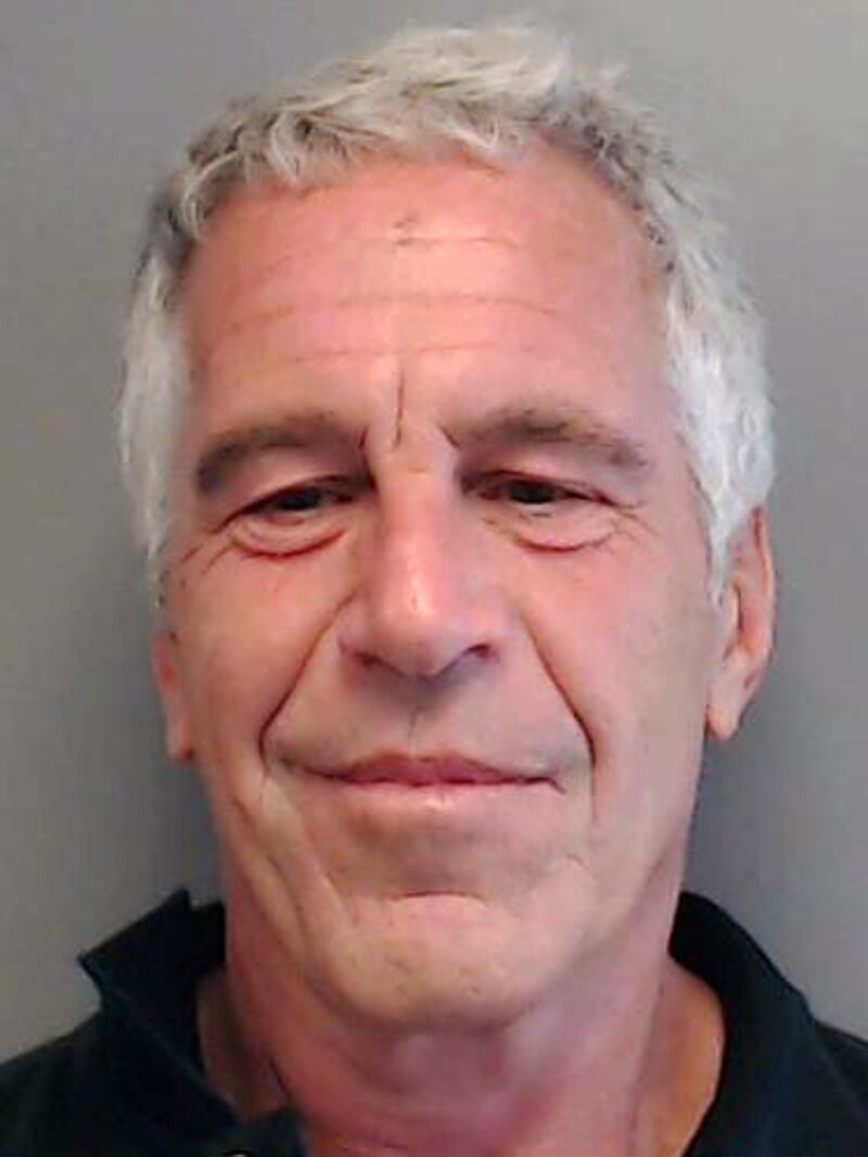 In this handout provided by the Florida Department of Law Enforcement, Jeffrey Epstein poses for a sex offender mugshot after being charged with procuring a minor for prostitution on July 25, 2013