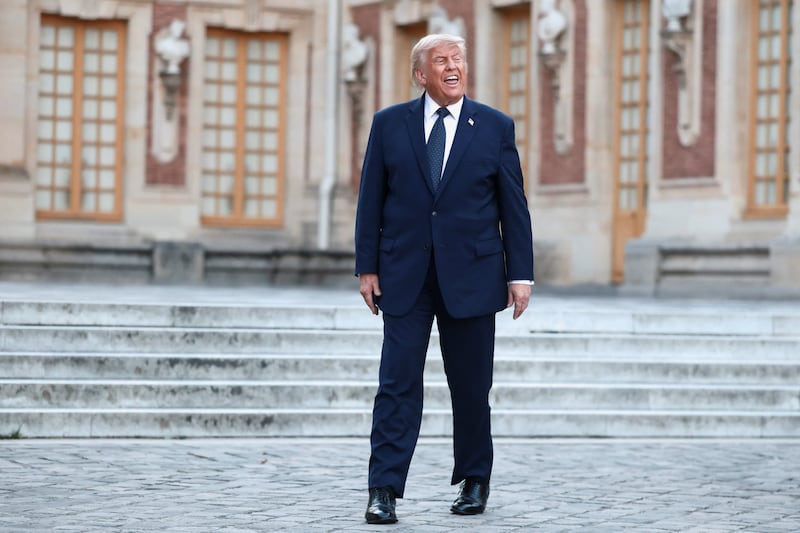 U.S. President Donald Trump is welcomed by French President Emmanuel Macron and his wife Brigitte Macron ahead of a dinner commemorating the 250th anniversary of the United States' independence, at the Palace of Versailles, near Paris, France, June 17, 2026.