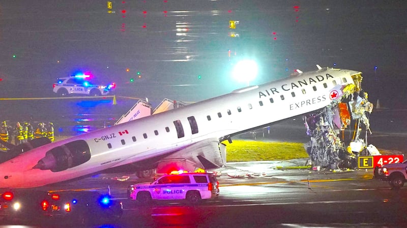 Emergency crews work around an Air Canada Express jet that had collided with a ground vehicle at New York's LaGuardia Airport in Queens, New York, U.S. March 23, 2026.
