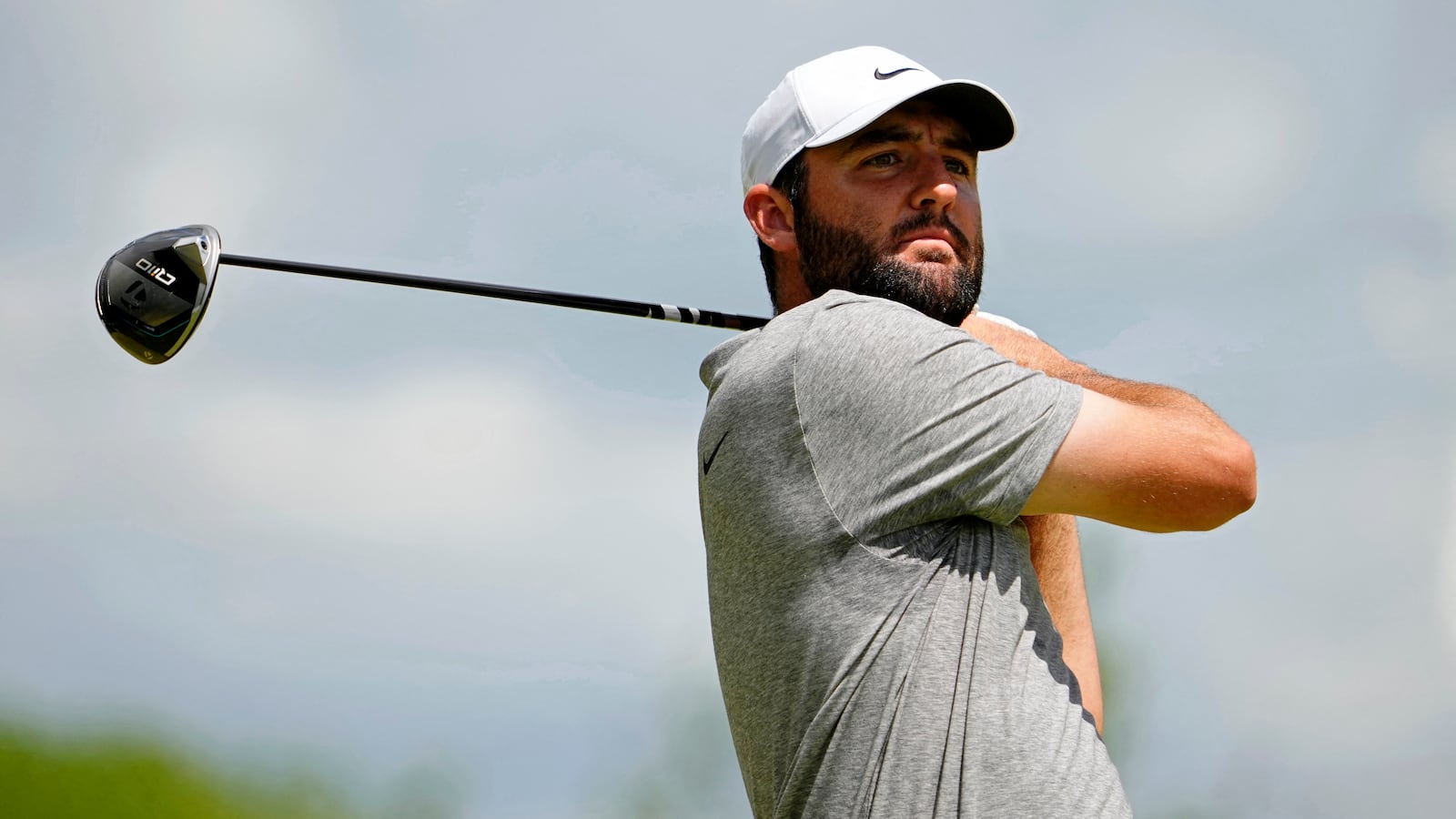 Scottie Scheffler tees off on the fifth hole during the third round of the PGA Championship golf tournament.