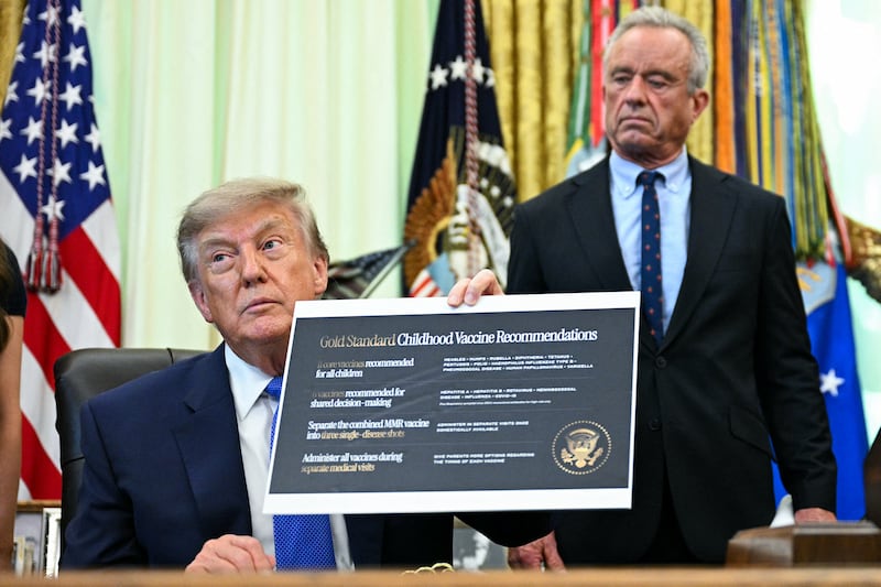 U.S. Secretary of Health and Human Services Robert F. Kennedy Jr. (R) looks on as President Donald Trump speaks before signing an executive order calling for more research and flexibility on vaccines