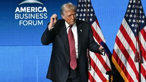 Trump dances on stage after speaking at the American Business Forum in Miami. Also on Wednesday, the Supreme Court heard arguments challenging his constitutionality of his tariffs.