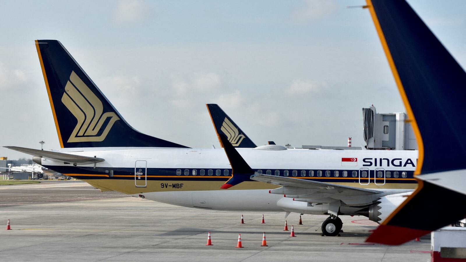 A Singapore Airlines planes sit on the tarmac.