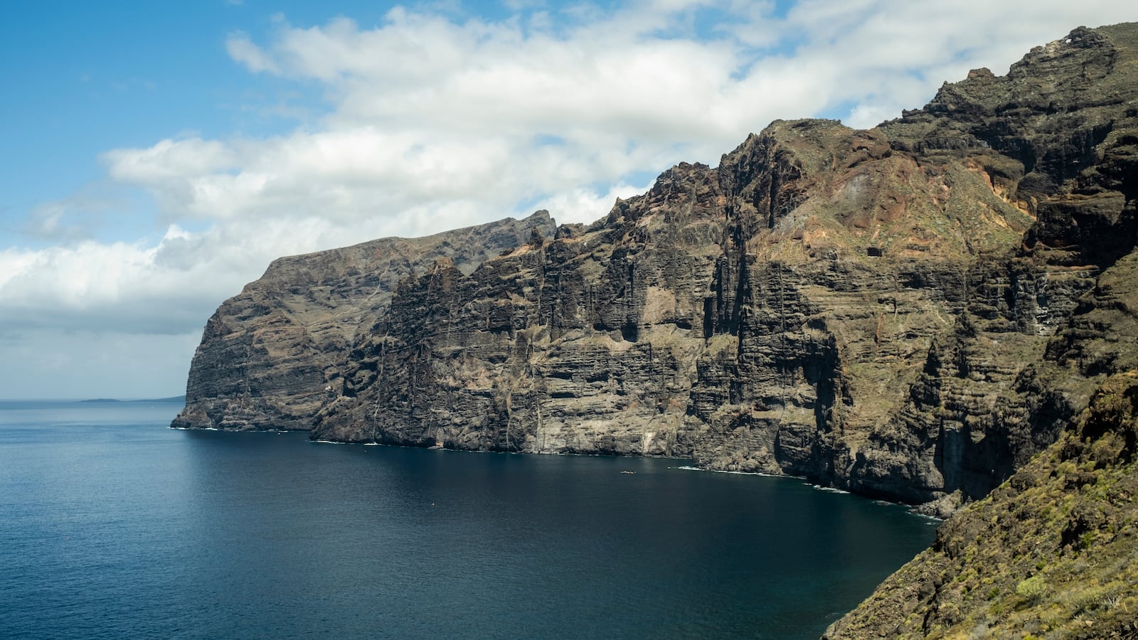 TENERIFE, SPAIN - MARCH 21: Cliff by Los Gigantes on March 21, 2023 in Tenerife, Spain. Tenerife is the largest of Spain’s Canary Islands, off West Africa. It's dominated by Mt. Teide, a dormant volcano that is Spain's tallest peak. The island has many beaches (with sands from yellow to black) and resort areas, including Los Cristianos and Playa de las Américas.