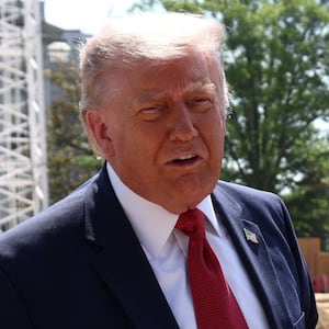 U..S. President Donald Trump shows images of the concept at the site of ongoing construction of the planned White House ballroom in Washington, D.C., U.S., May 19, 2026.
