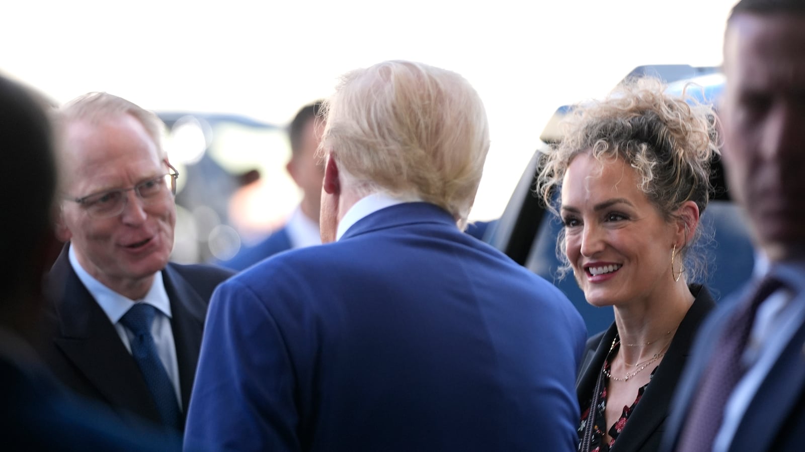 Donald Trump, speaks with David Limp, left, and Megan Mitchell, right in Austin, Texas.