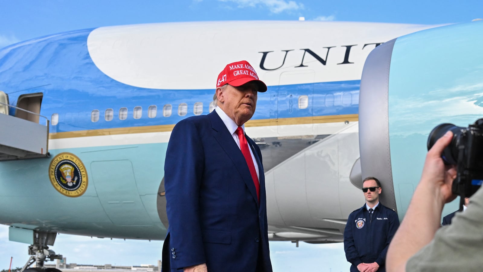US President Donald Trump speaks to reporters after landing at the Palm Beach International Airport in West Palm Beach, Florida on February 16, 2025 after attending the Daytona 500 car race earlier in the day. US President Donald Trump said Sunday he could meet "very soon" with Vladimir Putin, adding he believes his Russian counterpart genuinely wants to stop fighting in Ukraine. (Photo by ROBERTO SCHMIDT / AFP via Getty Images)