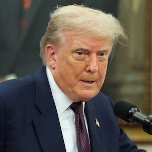 U.S. President Donald Trump speaks, as he and Apple CEO Tim Cook (not pictured) present Apple's announcement of a $100 billion investment in U.S. manufacturing, in the Oval Office at the White House in Washington, D.C., U.S., August 6, 2025. REUTERS/Jonathan Ernst