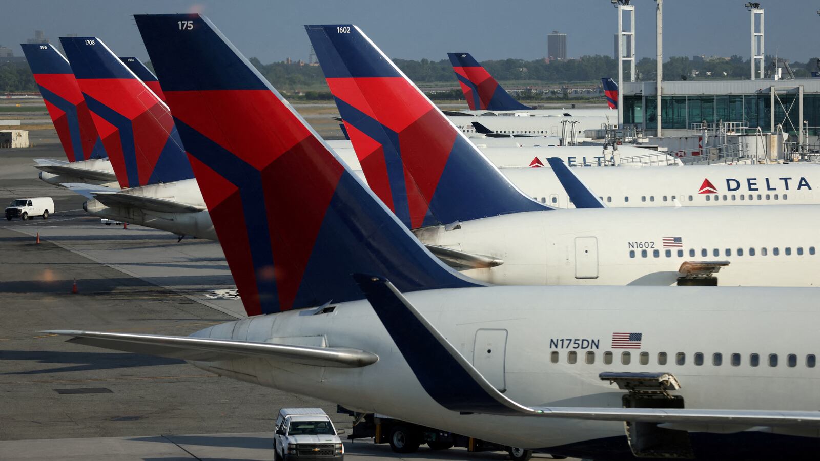 Six Delta Air Lines planes sit at their gates at an airport in New York City.