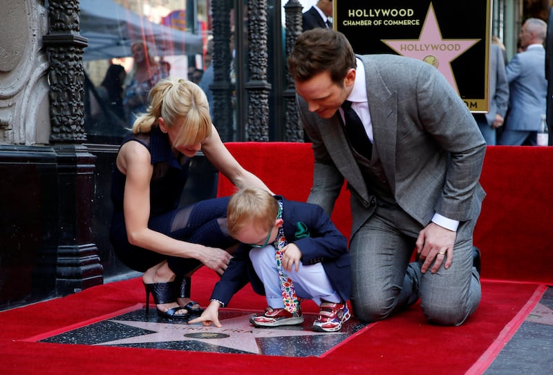 Actor Chris Pratt (R), his four-year old son Jack Pratt (C) and his wife Anna Faris (L) explore his new star on the Hollywood Walk of Fame during a during a ceremony honoring him with the star in Hollywood, California, U.S. April 21, 2017. REUTERS/Danny Moloshok