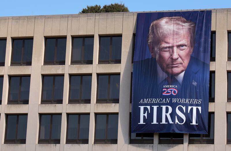 President Donald Trump’s face is plastered on a massive banner that now hangs from the side of the U.S. Department of Labor.
