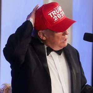 U.S. President Donald Trump wears a "Trump 2028" cap as he delivers remarks at the White House Correspondents' Association (WHCA) Dinner, which was rescheduled from April after it was interrupted when a man tried to force his way through security and fired a shotgun, at the Waldorf Astoria hotel in Washington, D.C., U.S., July 24, 2026. REUTERS/Jonathan Ernst